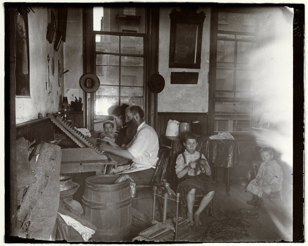 Bohemian cigar makers at work in their tenement. Jacob Riis