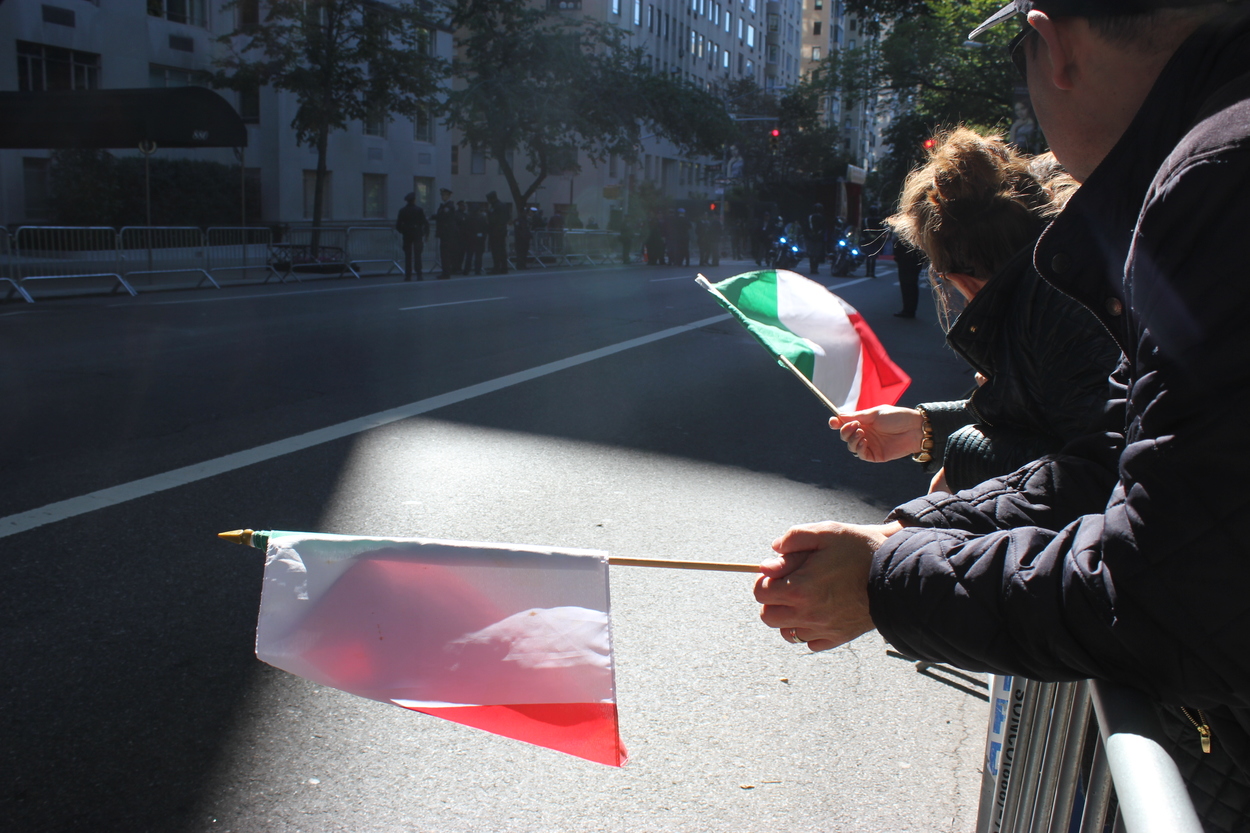 People waving Italian flags. (Photo Rebecca Katz)