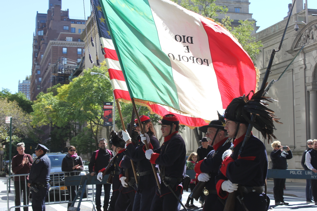 Carabinieri holding the flag with their motto.