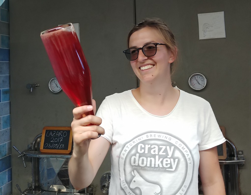 Giulia Masieri, Winemaker, Showing a Bottle of Their Pét-Nat 'Moki'