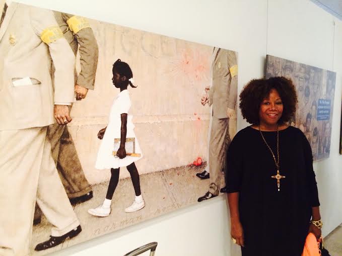 Ruby Bridges poses next to Norman Rockwell's painting The Problem We All Have (1964)